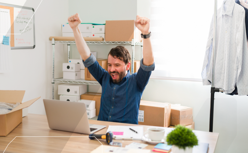 small business owner, celebrating at their desk